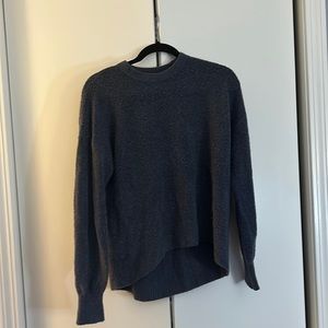 The blue sweater with some red in it it’s a boule type sweater .